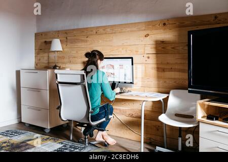Female architect using computer at home Stock Photo