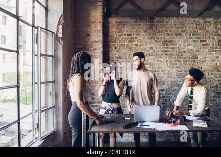 Creative team using Vr goggles in loft office Stock Photo