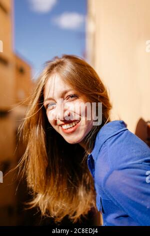 Portrait of happy young woman with nose piercing on balcony Stock Photo