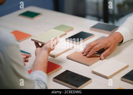 Hands of architects choosing colour samples in office Stock Photo