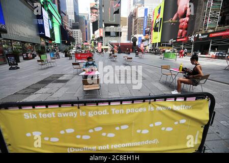 New York, USA. 23rd July, 2020. People are seen on Times Square in New York, the United States, July 23, 2020. The number of COVID-19 cases in the United States surpassed the 4 million mark Thursday to reach 4,005,414 as of 3:04 p.m. local time (1904 GMT), according to the Center for Systems Science and Engineering (CSSE) at Johns Hopkins University. Credit: Wang Ying/Xinhua/Alamy Live News Stock Photo
