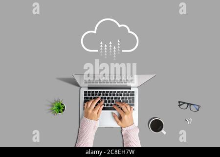 Internet Cloud Service Concept. Hand holds a smartphone on a green background Stock Photo