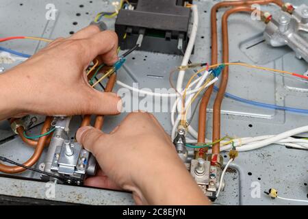 man fixing a gas cooker Stock Photo