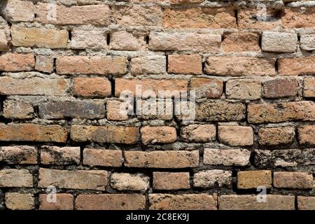 Weathered brick wall background showing vintage bricks, mortar and abstract lines and patterns. Stock Photo