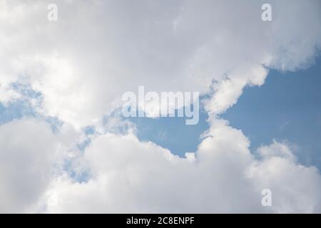 Blue Sky and White Fluffy Clouds in a Summer Day Stock Photo
