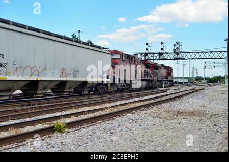 Franklin Park, Illinois, USA. A pair of Canadian Pacific Railway locomotives lead a freight train toward a green signal. Stock Photo