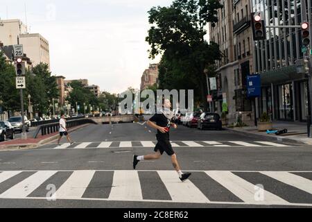 Washington, DC, USA. 23rd July, 2020. A man jogs in Washington, DC, the United States, July 23, 2020. The number of COVID-19 cases in the United States surpassed the 4 million mark Thursday to reach 4,005,414 as of 3:04 p.m. local time (1904 GMT), according to the Center for Systems Science and Engineering (CSSE) at Johns Hopkins University. Credit: Liu Jie/Xinhua/Alamy Live News Stock Photo