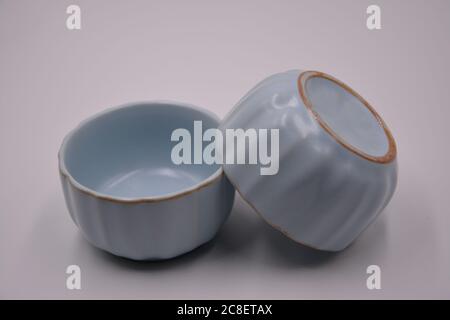 side view of couple light blue ceramic cups with white background Stock Photo