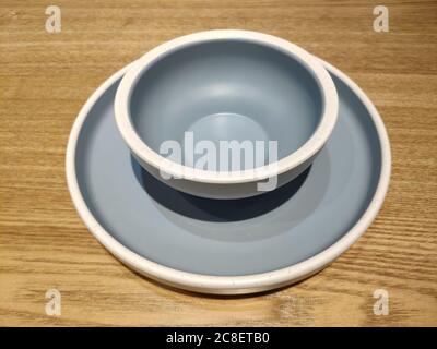 a set of light blue plate and bowl on the wood table Stock Photo