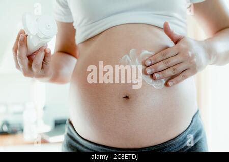 Happy pregnant woman and expecting baby at home. Stock Photo