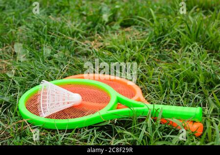 Two children's tennis rackets with a shuttlecock. Outdoor activities with children. Selective focus. Stock Photo