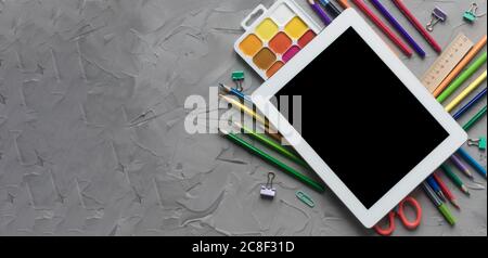 School supplies center composition on grey .concrete background Stock Photo