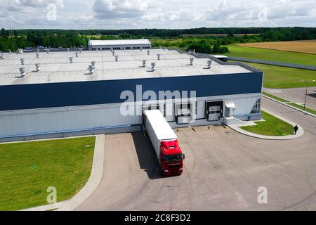 Aerial view of trucks parked in front of industry building. Aerial. Stock Photo