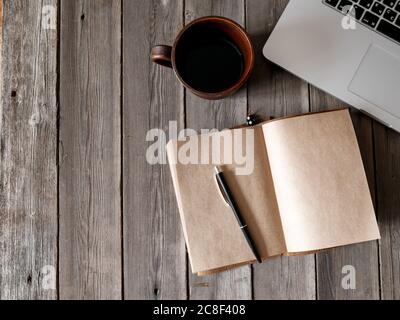 Office desk with blank screen smartphone,pen,notebook and coffee cup on wood table.Top view with copy space.Office supplies and gadgets on desk table.Working desk table concept.Flat lay image. Stock Photo
