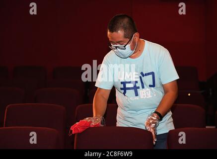 Beijing, China. 24th July, 2020. A staff member disinfects the UME Cinema (Huaxing branch) in Beijing, capital of China, July 24, 2020. Part of cinemas in Beijing resumed operations on Friday with effective epidemic prevention measures in place. Credit: Ren Chao/Xinhua/Alamy Live News Stock Photo