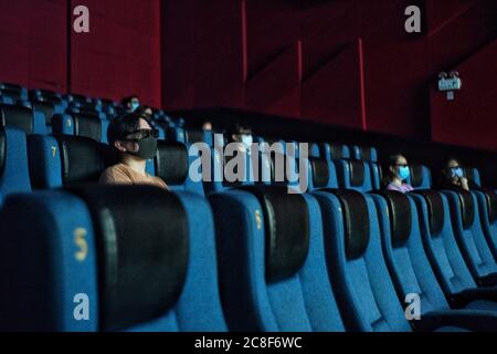 Beijing, China. 24th July, 2020. People watch a movie at the Capital Cinema (Xidan branch) in Beijing, capital of China, July 24, 2020. Part of cinemas in Beijing resumed operations on Friday with effective epidemic prevention measures in place. Credit: Peng Ziyang/Xinhua/Alamy Live News Stock Photo
