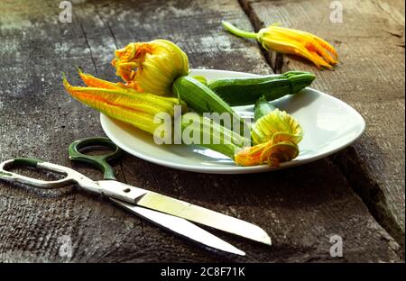 Zucchini flowers on the old wooden table Stock Photo