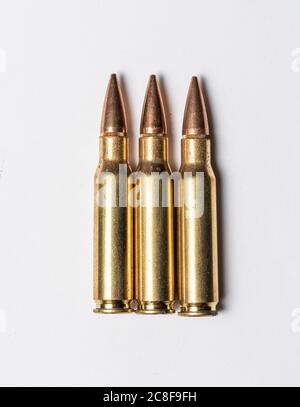 Three rifle bullets on white background. Stock Photo