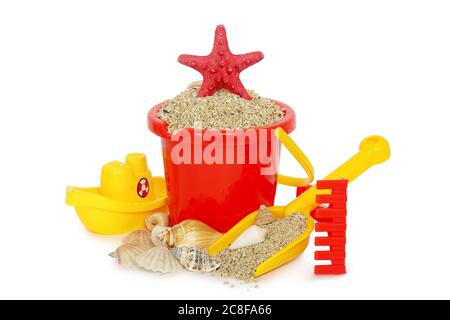 beach toys with sand and seashells isolated on white Stock Photo