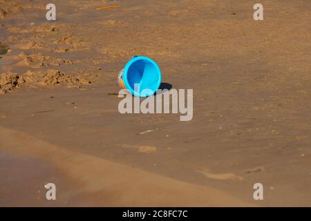 Blue, baby bucket on the beach. Sandy shore. High quality photo Stock Photo