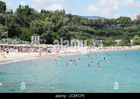 Varna, Bulgaria - July, 19, 2020: people sunbathe and swim on the sea beach Stock Photo