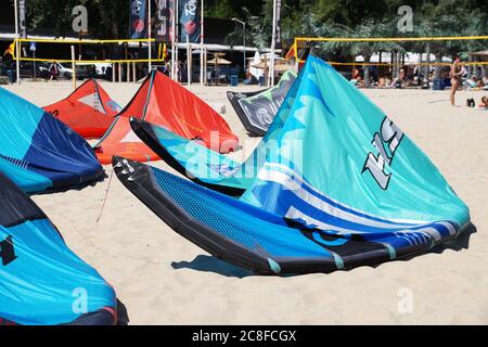 Varna, Bulgaria - July, 19, 2020: multi-colored parachutes for kiting on the sandy beach Stock Photo