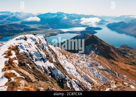 Snow capped ridge lines on the Roys Peak Track during winter in Wanaka, New Zealand Stock Photo