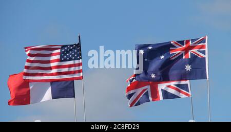 Four National Country Flags Flying on a Sunny Day. Stock Photo