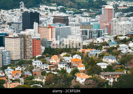 Wooden and brick houses against the rectangular concrete office blocks in Wellington, New Zealand Stock Photo