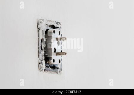 AC power plug during the instalation on the wall. Repair time Stock Photo