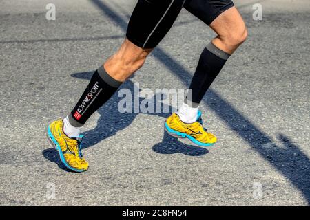 Ekaterinburg, Russia - August 7, 2016: legs man runner in shoes Mizuno and compression socks Compressport in Europe-Asia Stock Photo