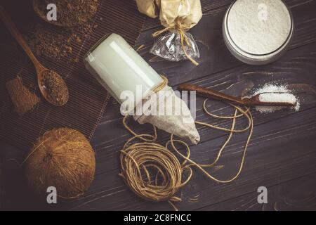 Coconut oil and coconuts. Organic coconut products for spa. Coconut oil in glass jar. Coconut oil on table. Stock Photo
