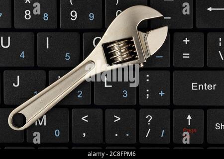 wrench on computer keyboard, computer repair concept Stock Photo