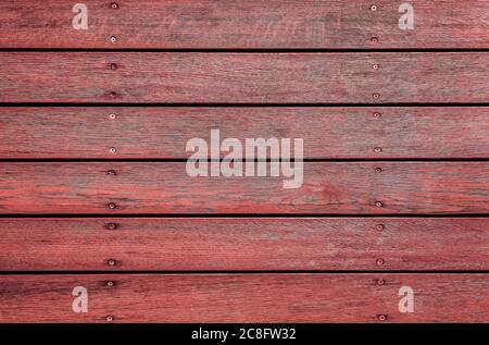 Red horizontal wooden texture for background or mockup. Rustic painted wood texture close up. Barn wall or fence. Flat wood banner, billboard or signb Stock Photo