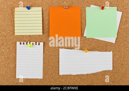 variety of pinned blank notes on cork notice board Stock Photo
