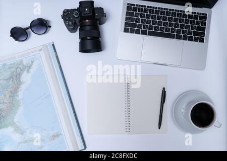 Travel planning, map, camera, notebook and cup of coffee on white background Stock Photo