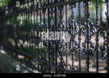 Wrought iron tracery black fence fragment. Elegant decorative cast iron fence. Stock Photo