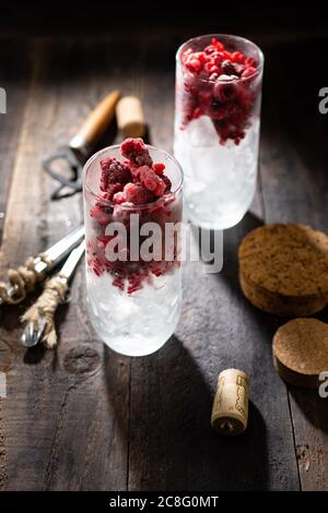 Refreshing summer drink with ice and raspberries.Healthy food and sweets.Vintage style. Stock Photo