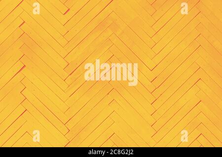 yellow wall textured background with painted wooden boards arranged in herring bone pattern Stock Photo