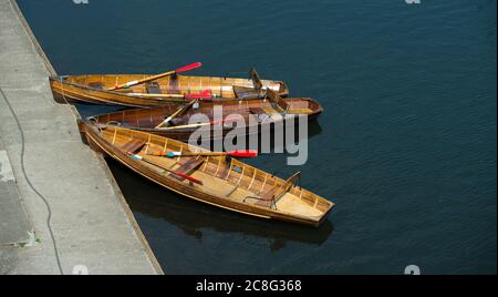 Wooden rowing boats moored on the River Wear in the cathedral city of Durham, County Durham, England. Stock Photo