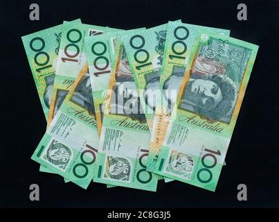 One hundred dollar notes on black background, Australian currency Stock Photo