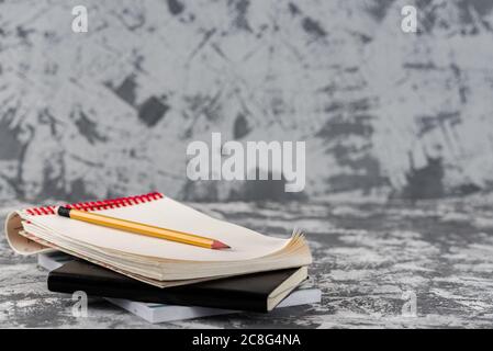 Sketchbook Notepad With Wood Pencil on stone Table Desk Background, loft Style, Concept and Idea for Write Your Text Here. Stock Photo