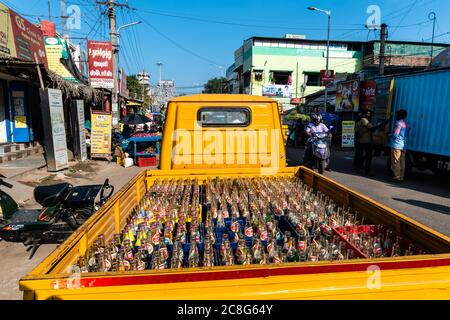 Trichy, Tamil Nadu, India - February 2020: A truck painted yellow transporting bottles of cold drink. Stock Photo