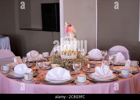 Table served in city hotel, birthday celebration, patisserie and themed decoration, interior with tables and tablecloth. Stock Photo