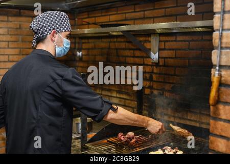 Chef grilling steaks in commercial kitchen. High quality photo Stock Photo