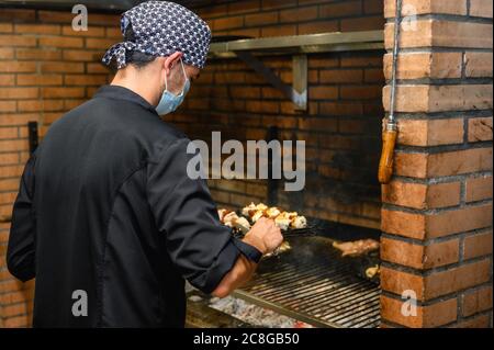 Chef grilling steaks in commercial kitchen. High quality photo Stock Photo