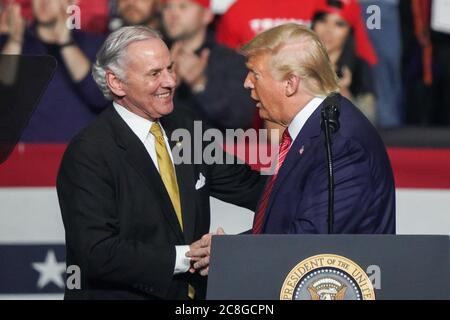 U.S. President Donald Trump, right, greets South Carolina Governor Henry McMasters during the Keep America Great Rally in the North Charleston Coliseum February 28 2020 in North Charleston, South Carolina.