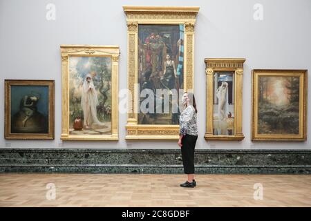 London, UK. 24th July, 2020. An assistant looks at various works in the Pre-Raphaelite collection. Tate Britain, along with other Tate Galleries in the country will re-open to visitors from Monday, 27th July with social distancing measures in place. Credit: Imageplotter/Alamy Live News Stock Photo