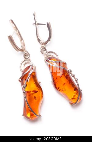 Amber earrings shot from above, isolated on white Stock Photo