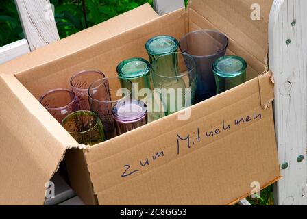 Drinking glasses to take away ( zum Mitnehmen ) in a carton by the road Stock Photo